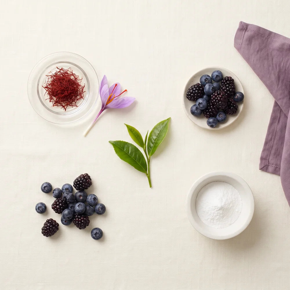 Saffron threads, a saffron flower, blueberries and blackberries on a kitchen table