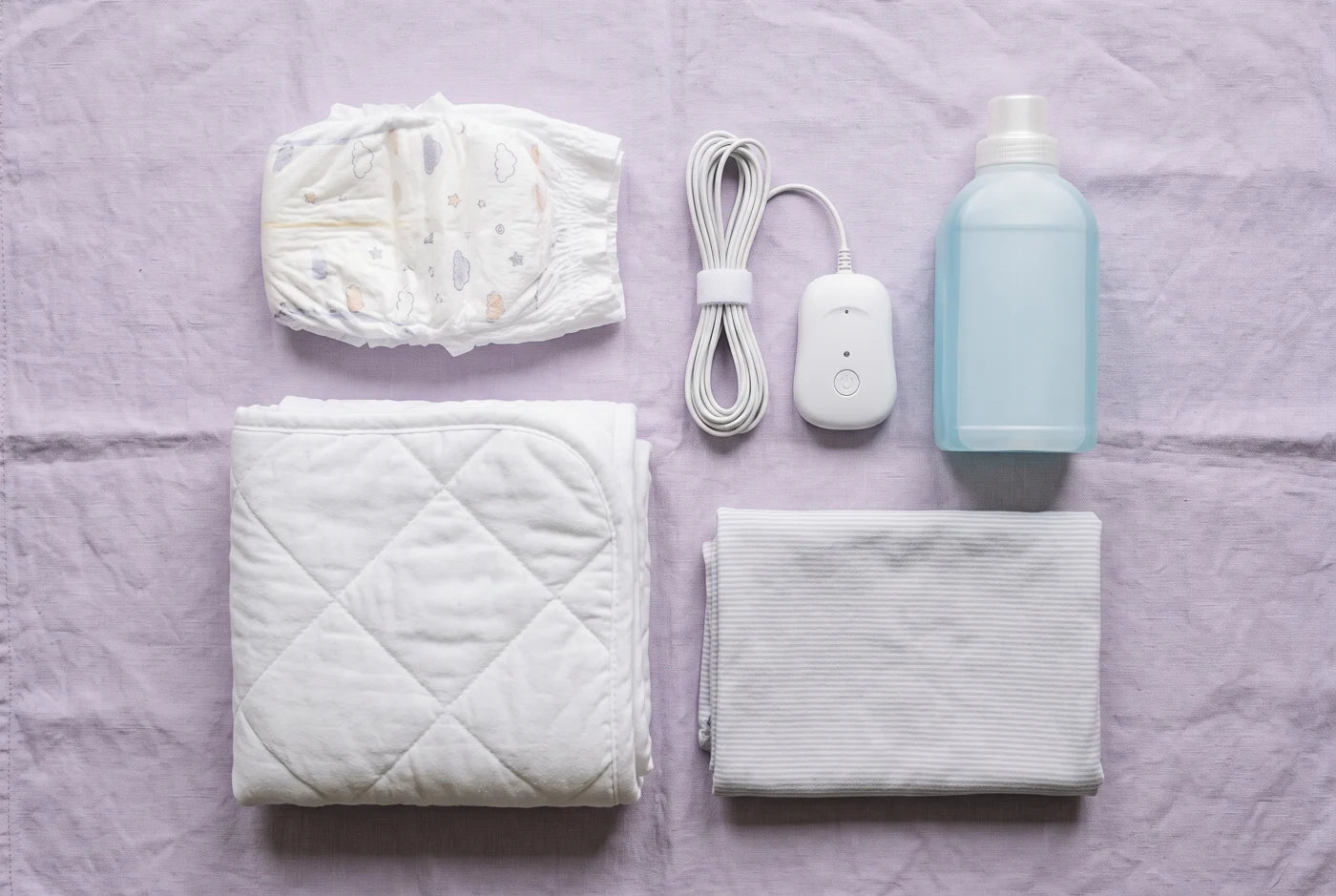 Pull-up, bedwetting alarm, mattress pad and detergent laid out