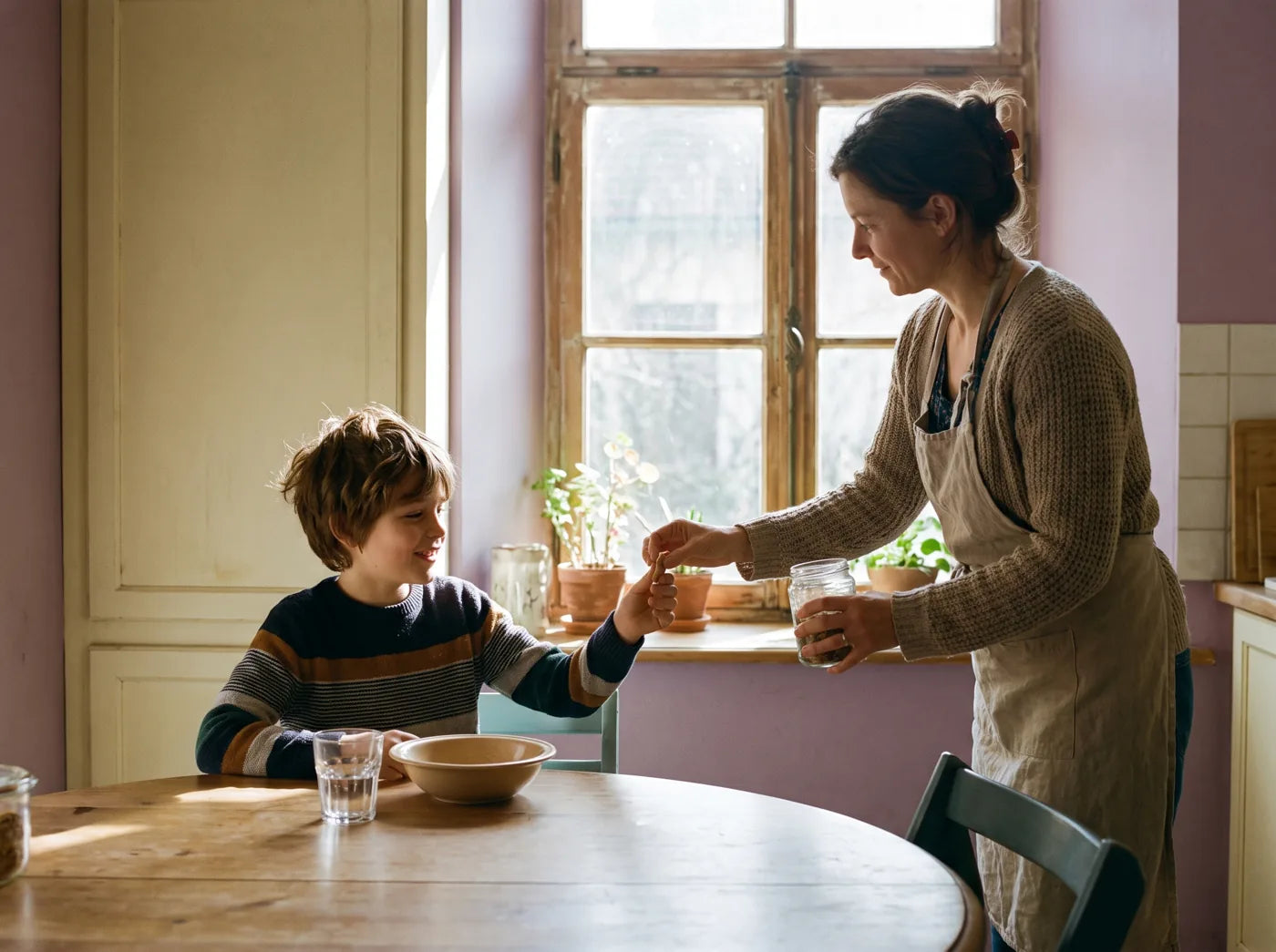 A mom handing her son a meltable at the breakfast table